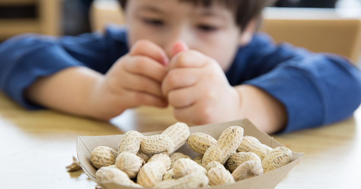 Boy about to eat peaanuts